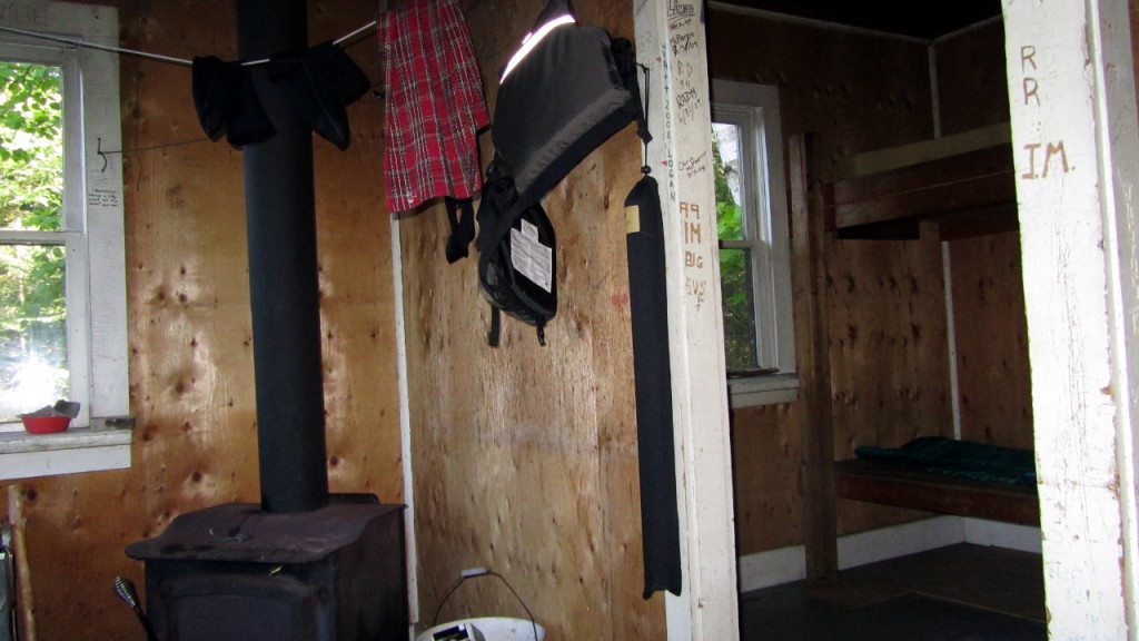 Wood burning stove and one of the bedrooms inside the ranger cabin